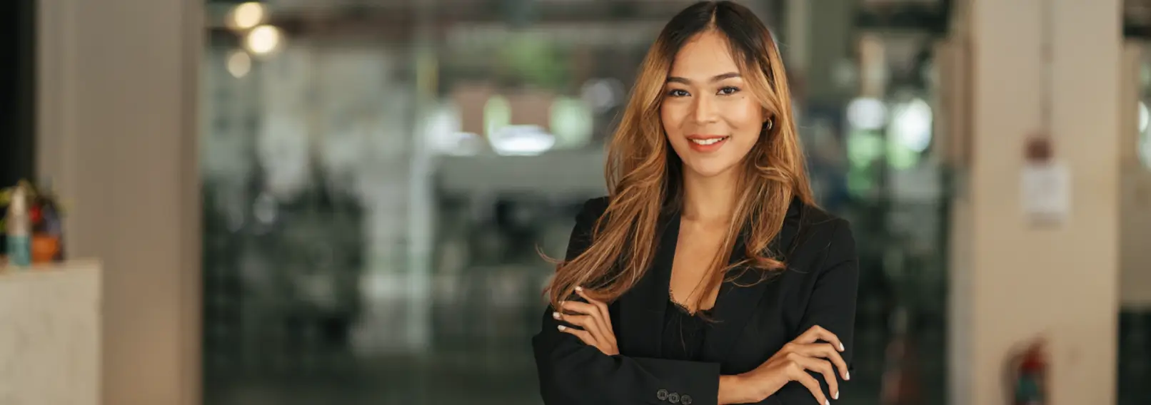 Young woman wearing a black suit jacket.